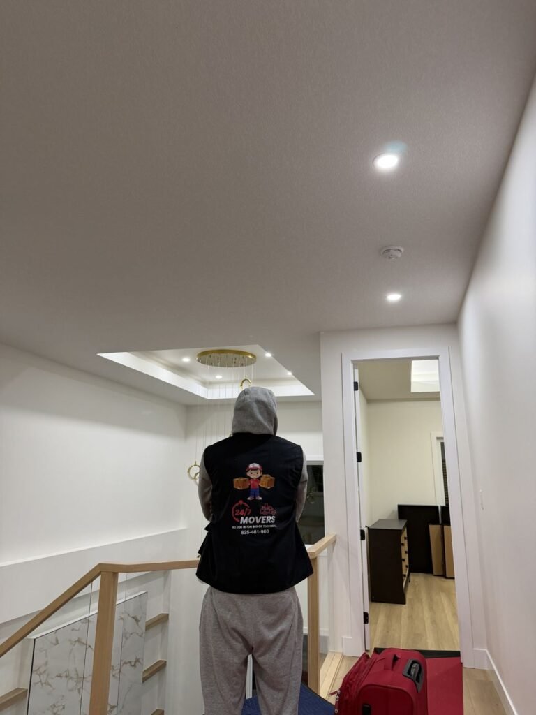 247 Movers Inc. crew member in branded vest during an Edmonton home move