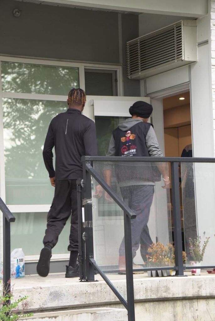 247 Movers crew entering an Edmonton condo building