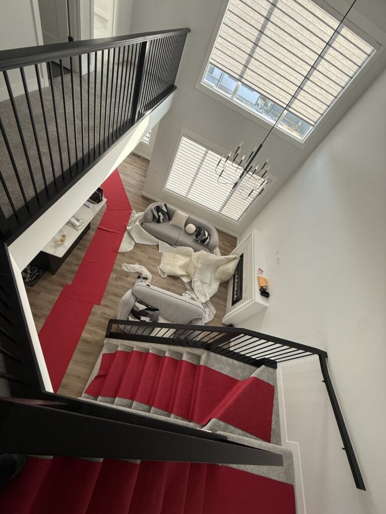 Red floor protection runners laid through a home during a move