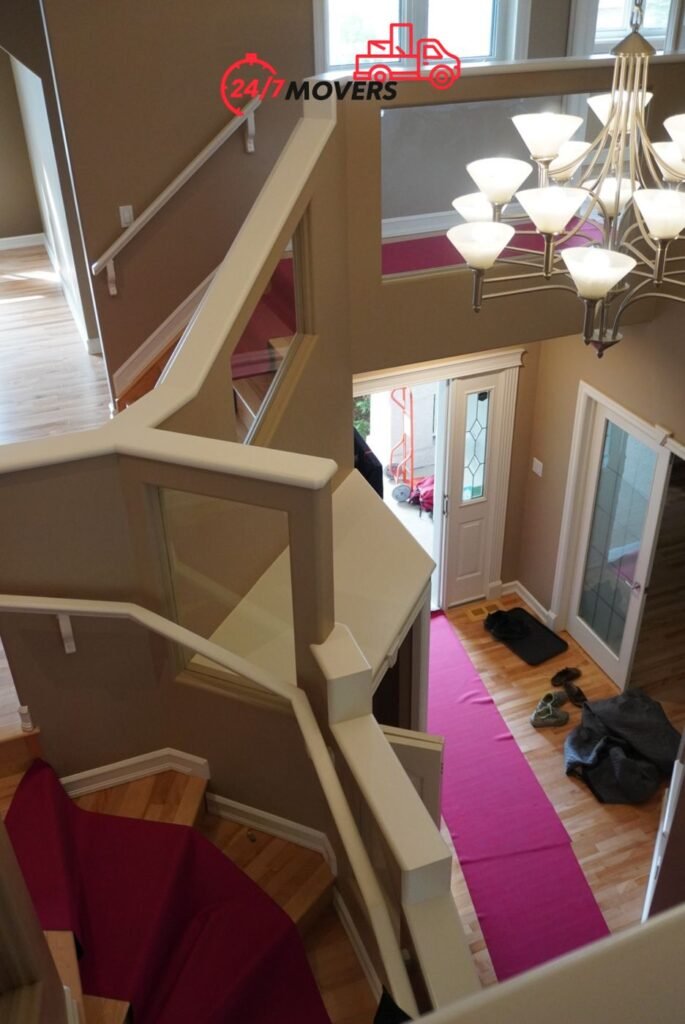 Foyer and staircase covered with floor runners during a house move