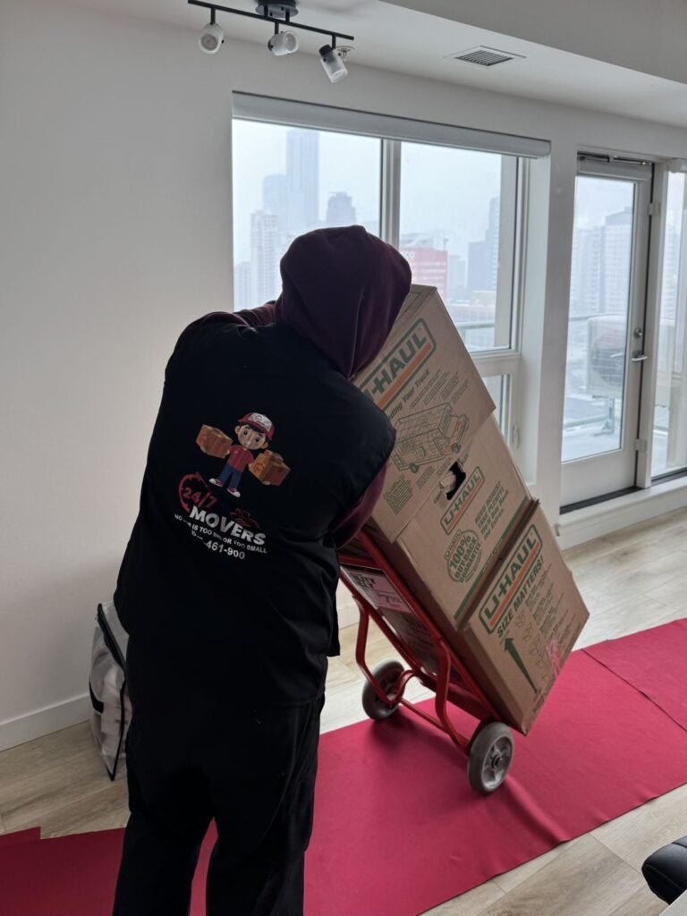 Mover using a dolly to move boxes across floor runners in a high-rise condo