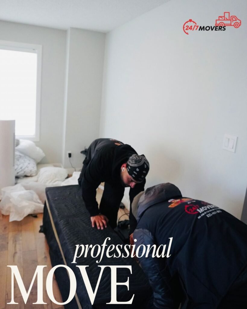 Two movers wrapping a mattress in a moving blanket