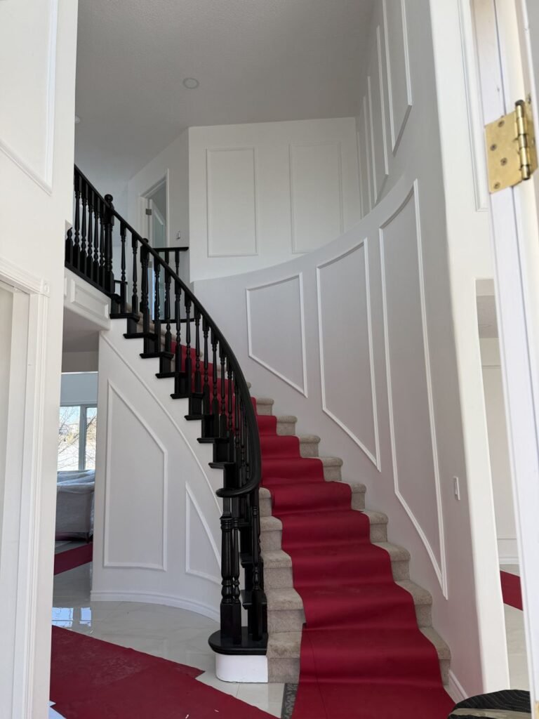 Curved staircase protected with red floor runners during a move